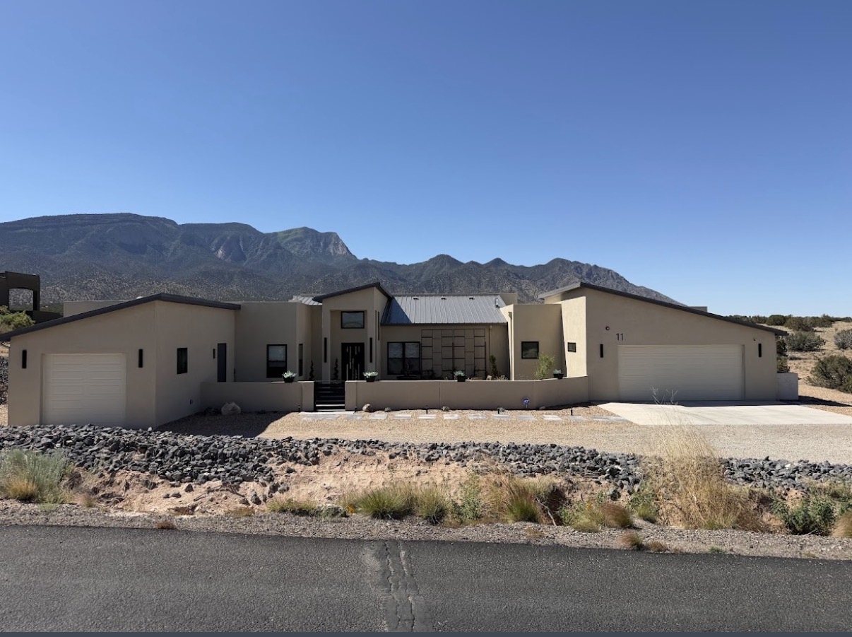 Completed contemporary New Mexico residence set against the Sandia Mountains